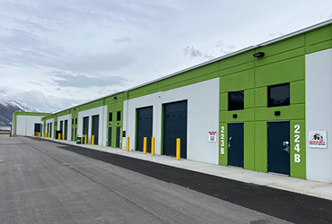 A large warehouse space with a now leasing sign hanging on the front.